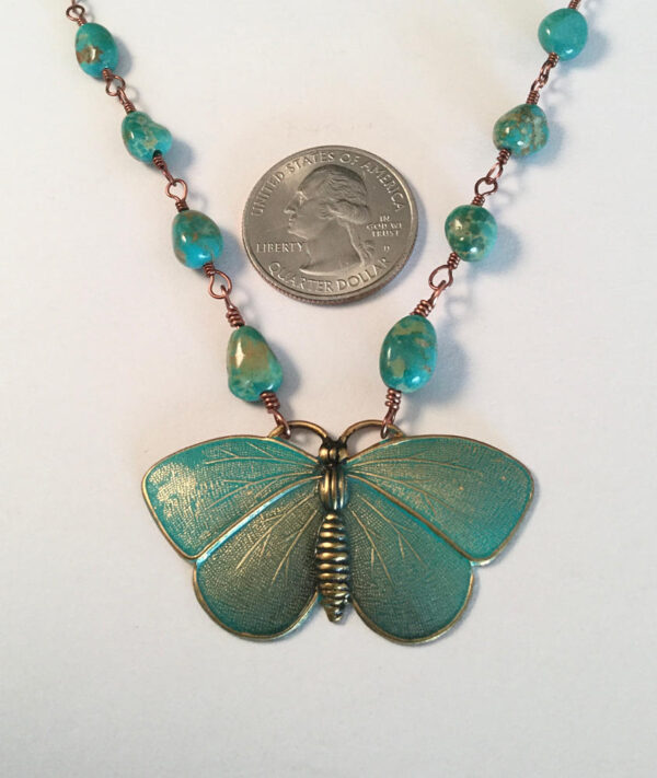 close up of butterfly necklace by Claudia Chavez