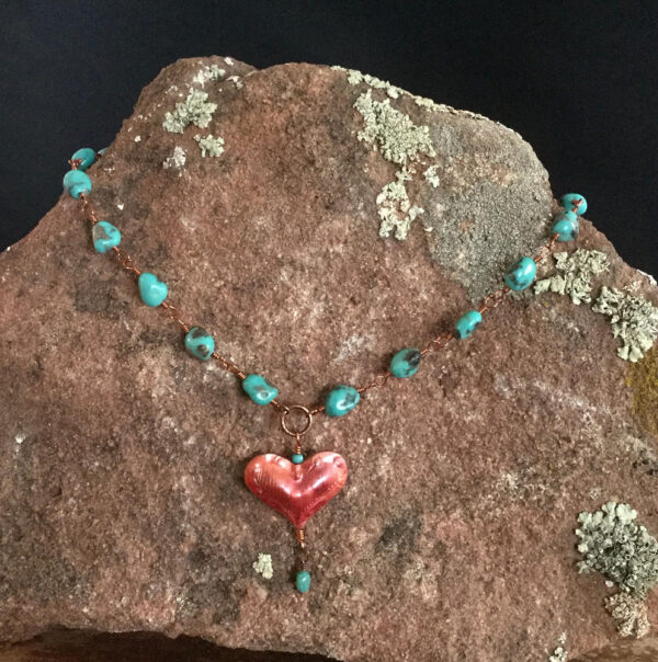 heart necklace on rock